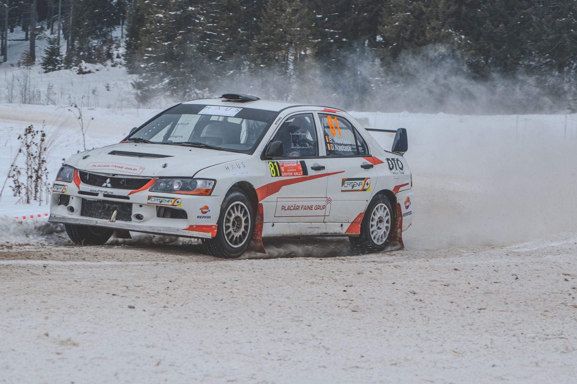 Jak przygotować się do rajdu zimowego jazda po śniegu dobór opon szpery i ustawień zawieszenia w niskich temperaturach Rajdowe Mitsubishi driftuje na zaśnieżonej drodze w Rumunii